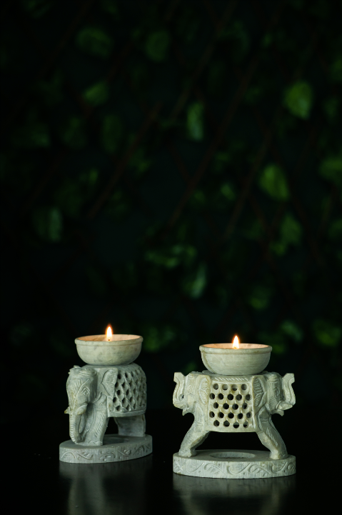 A soap stone elephant  candle stand with a jaali detail for this Diwali Decor