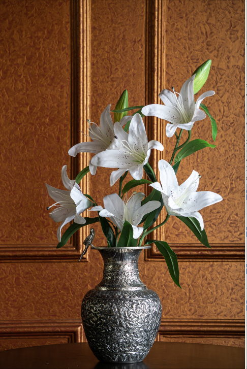 An array of flowers is featured on its body, beaten into metal, finished with a lacquer polish. The vase also features a bird on its side, as to show its attraction to the flowers. 