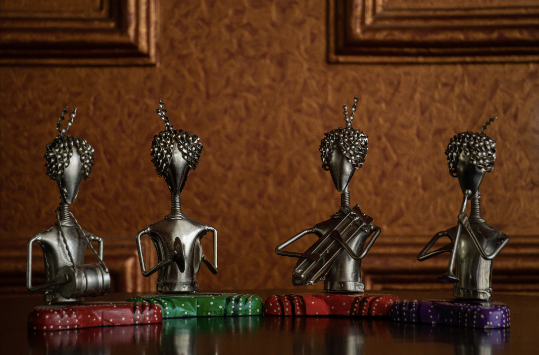 A set of Silver men sitting in a mehfil setting making for a unique home decor decorative piece set.