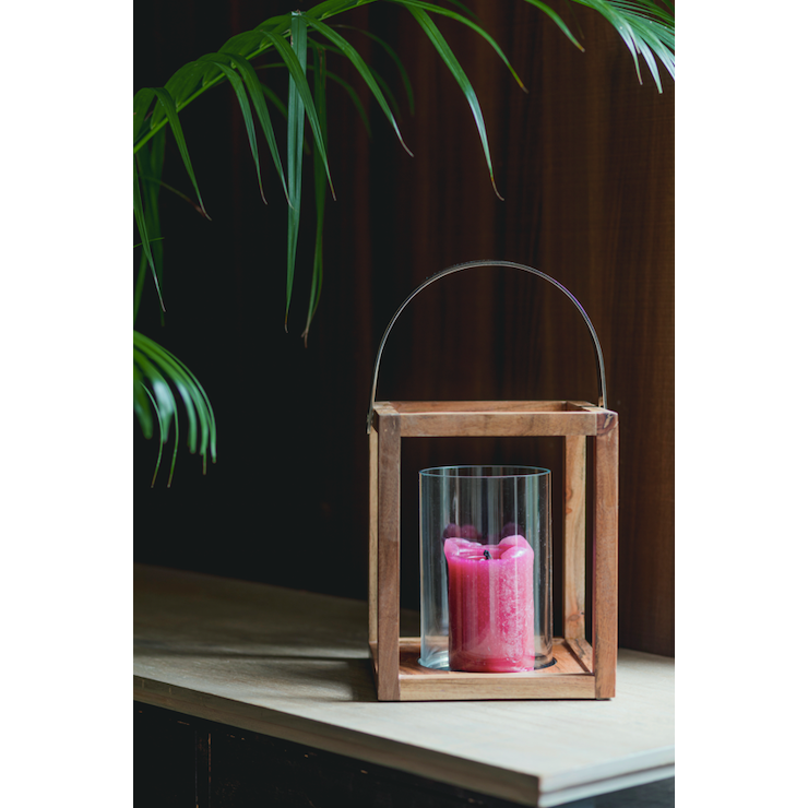 Structural wooden lanterns made of mango wood with a metal handle on top and a cylindrical glass candle holder within