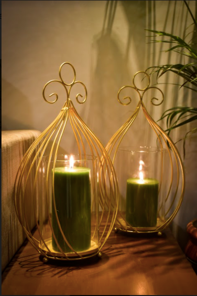 Netter Candle Stands are Made of Metal with Gold Finish and a Glass Candle Container Within.