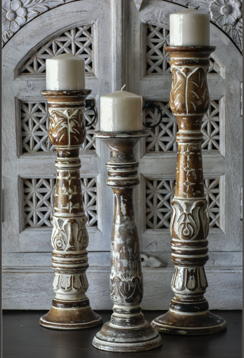 Grove Candle Stands Attention to the details must be given to these rustic candle stands. Hand carved details compliments the handmade structure made using mango tree wood. Comes in a set of 3