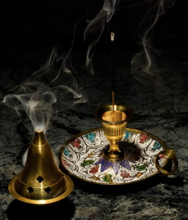 A Beautiful Brass Diya, with hand painted mosaic details within, with a finger handle on the side for better support.