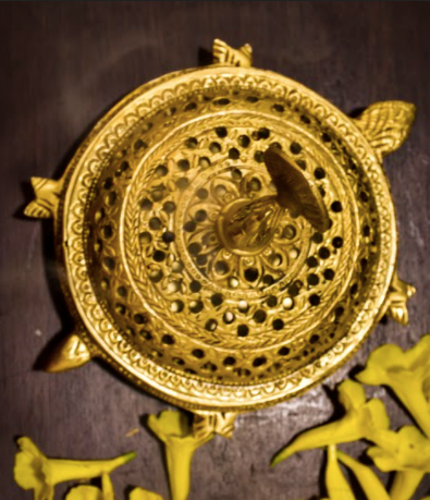 A Brass Round Dhoop Dani, Used to disperse the dhoop incense throughout the house/living space.