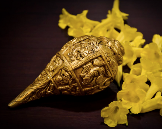 A Brass Shankh / Conch with detailed Ganesha carvings all around.