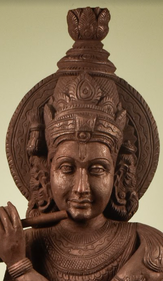 A Wooden Krishna Statue, made of mango wood, hand carved into lord krishna playing his flute.