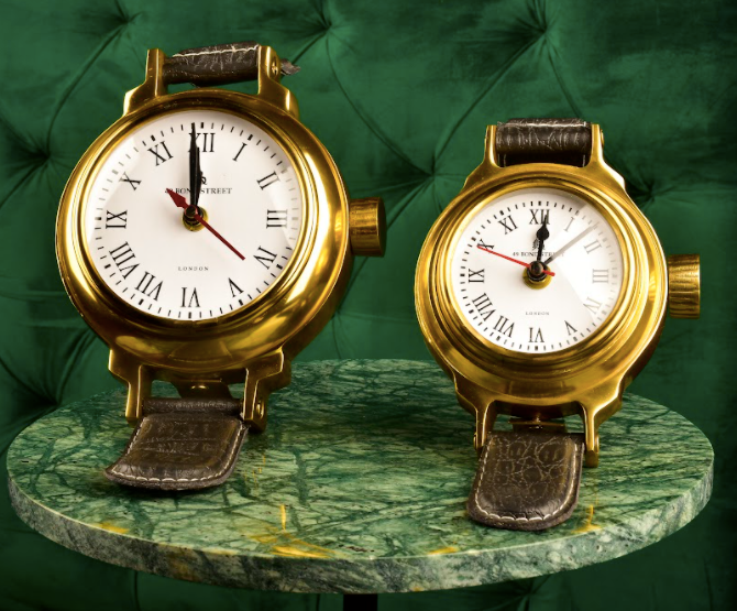 Modelled after a wrist watch, these shelf decor accessories are clocks that actually work, with a brass dial along with leather straps, with the bottom strap supporting the motif for stability