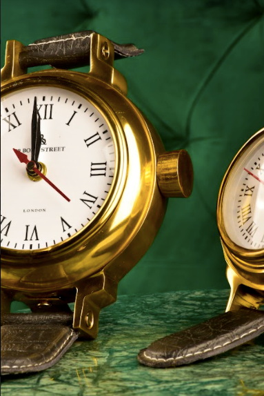 Modelled after a wrist watch, these shelf decor accessories are clocks that actually work, with a brass dial along with leather straps, with the bottom strap supporting the motif for stability