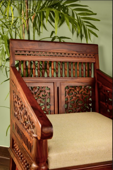A Chair Made of mango wood, the chair is hand-carved with intricate details inspired by royal living. 