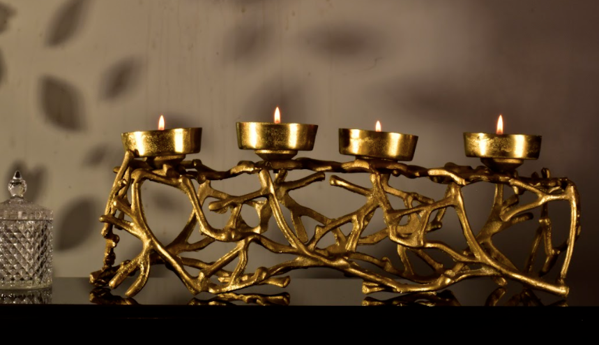 Made of Metal, this beauty has provisions for four candle holders mounted on a jungle of metal branches.