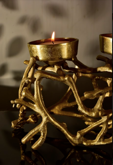 Made of Metal, this beauty has provisions for four candle holders mounted on a jungle of metal branches.