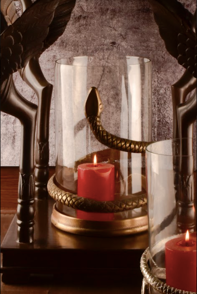 A Candle Stand Made With A Clear Glass Body Wrapped With A Snake Detail In A Rustic Silver & Gold Finish.