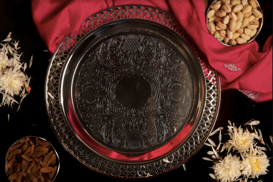 A Metal Tray In silver Finish With An Engraved Body Along With A Jaali Border