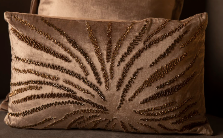 With a Sultry Grey, The Cushion has hand sewn gold details running throughout the cushion