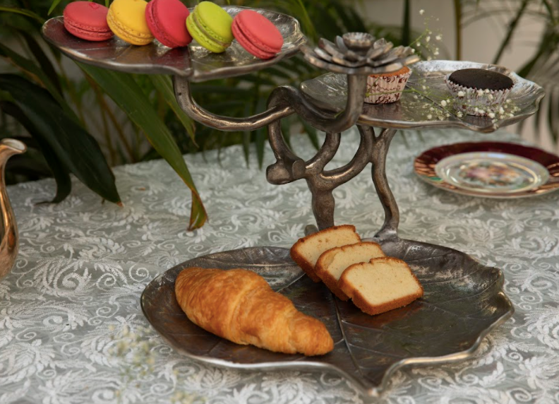 A 3-Tier, Rustic Metallic Food Stand In The Image Of A Petal With A Pencil Candle Holder.