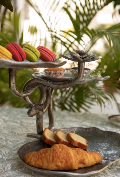A 3-Tier, Rustic Metallic Food Stand In The Image Of A Petal With A Pencil Candle Holder.