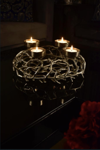 Made in the shape of a barbed wire Made of Metal in a rustic silver finish. Can hold upto 4 candles.