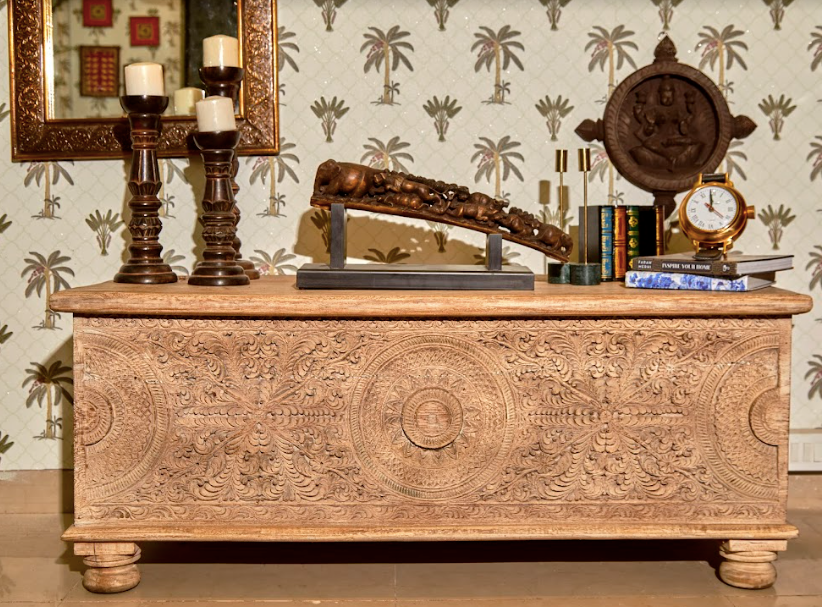 A Console Set Up Consisting Of a wooden console, wooden tusk, wooden candle stands, Emerald candle stands, book box showpiece & A Watch Showpiece