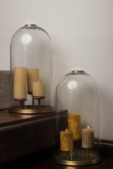 Glass domes dawning the brass stands with 3 candle holders installed within. These come in a pair of two