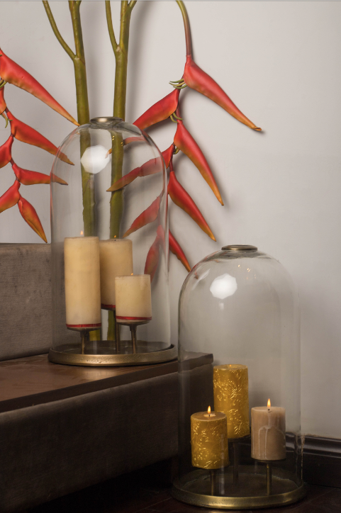 Glass domes dawning the brass stands with 3 candle holders installed within. These come in a pair of two