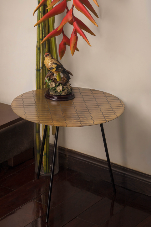A Brass Table is topped with a geometric pattern.