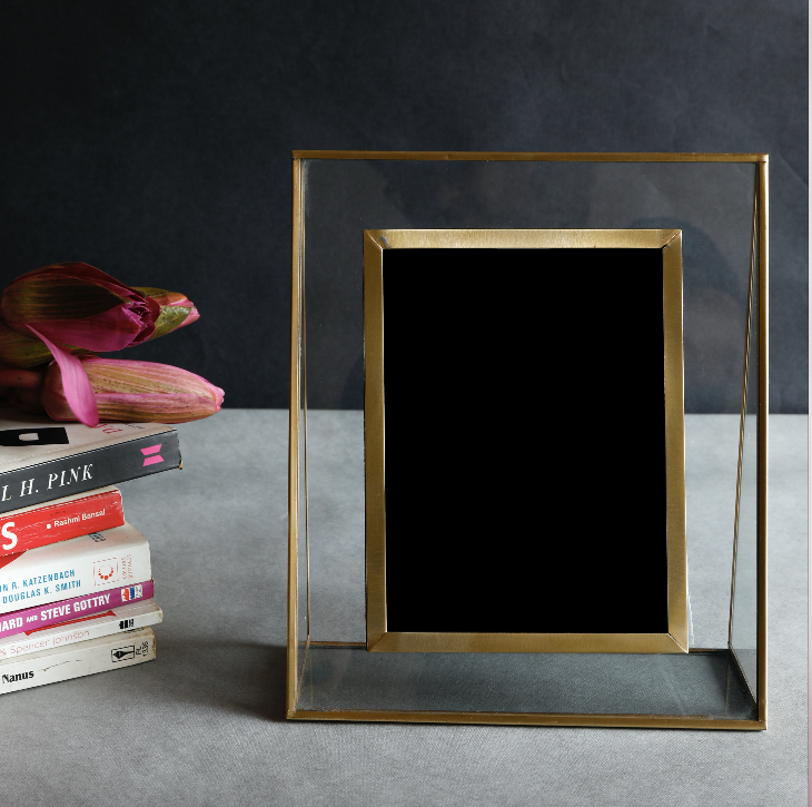 A Sleek, Gold & Glass Photo Frame, Made of Brass with a Wooden Stand mounted behind for support.