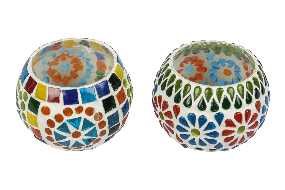 A Colourfull blue pottery tea light holder, with multicoloured glass work on the exterior.